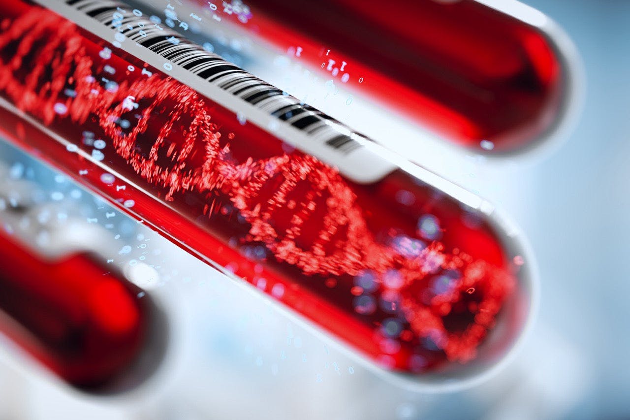 Close-up of a test tube filled with red liquid, containing a visible DNA helix, symbolizing the potential insight held within the DNA that can come from the testing.